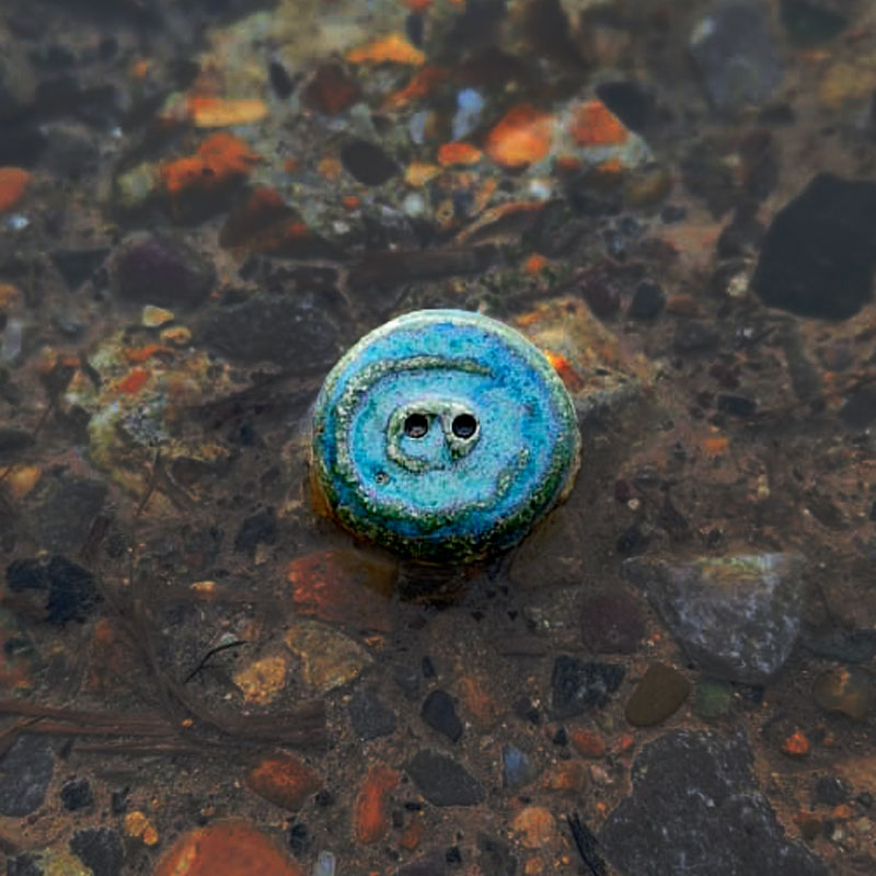 Blue button in shallow water