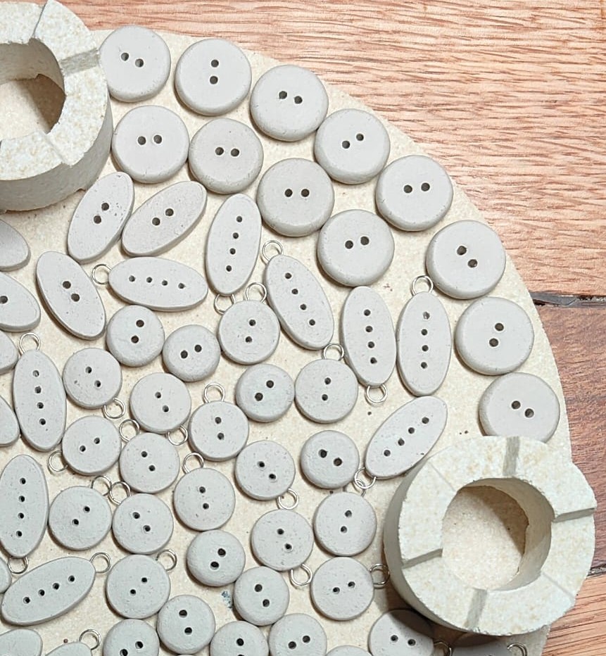 Bisqued buttons on shelf